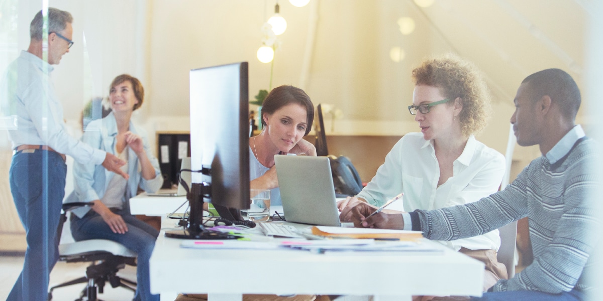 coworkers discussing at workdesk