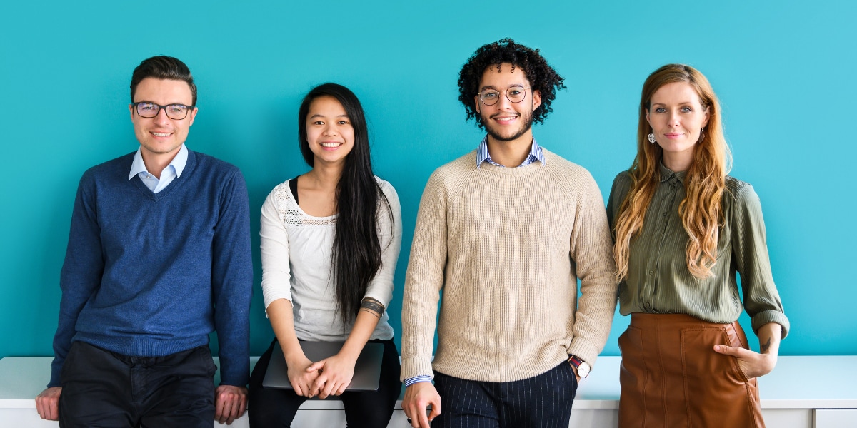 office colleagues standing in front of partition wall