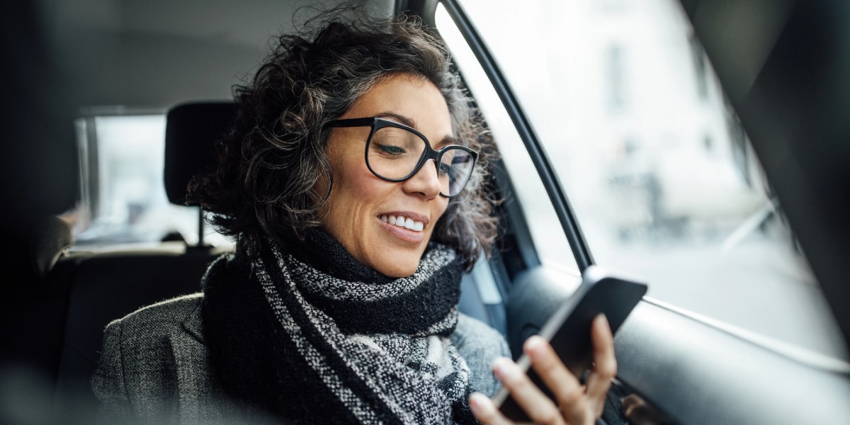 person sitting in car looking at mobile