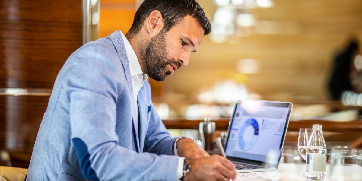 person-writing-sitting-at-work-desk